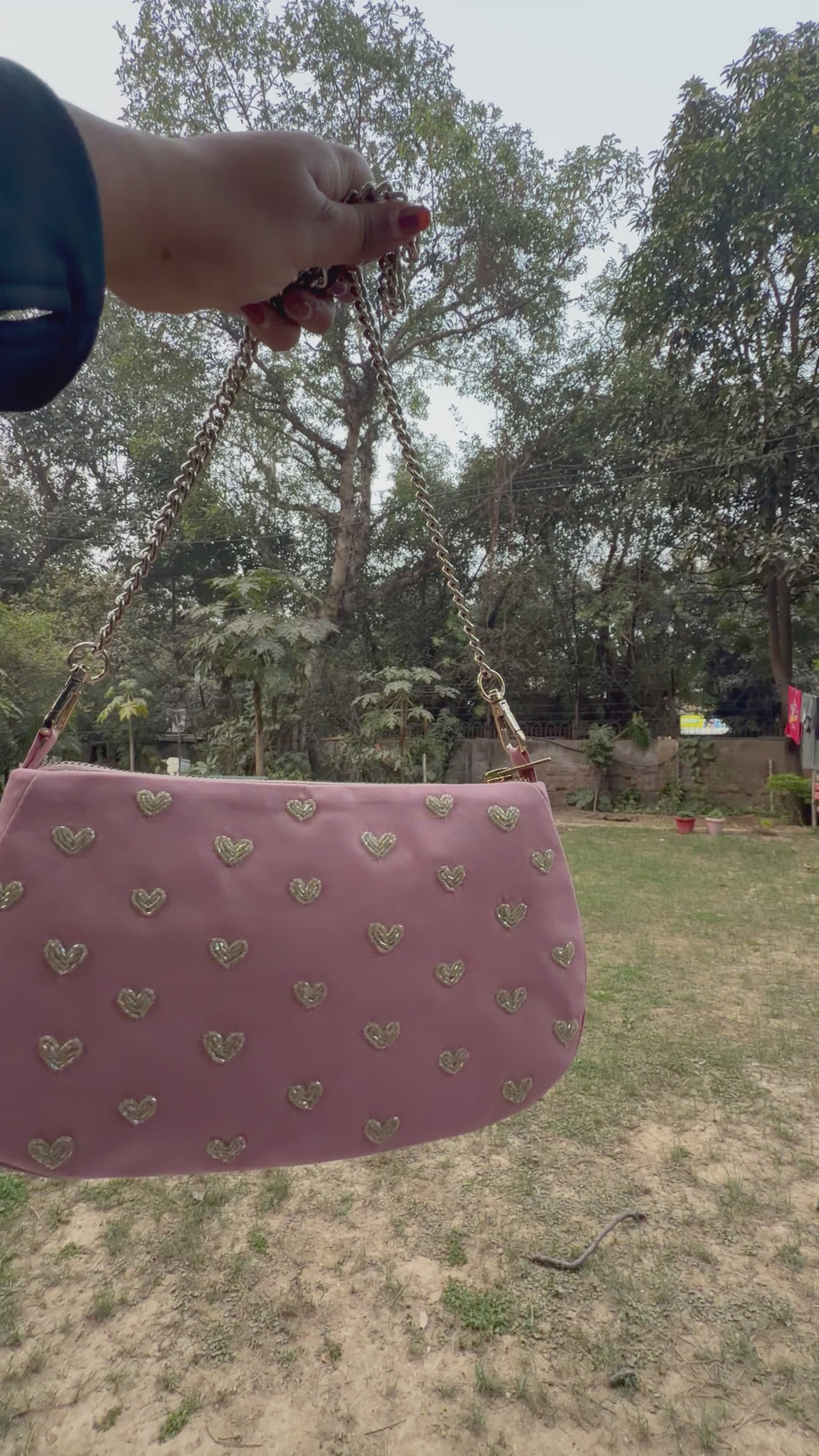 Pink hearts embroidered shoulder bag.